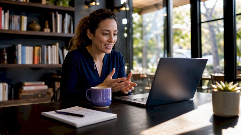 Woman engaging in conversational marketing chat on laptop