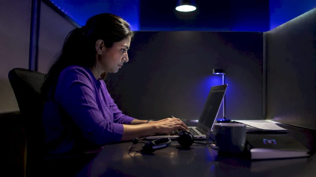 Woman working on after-hours support automation