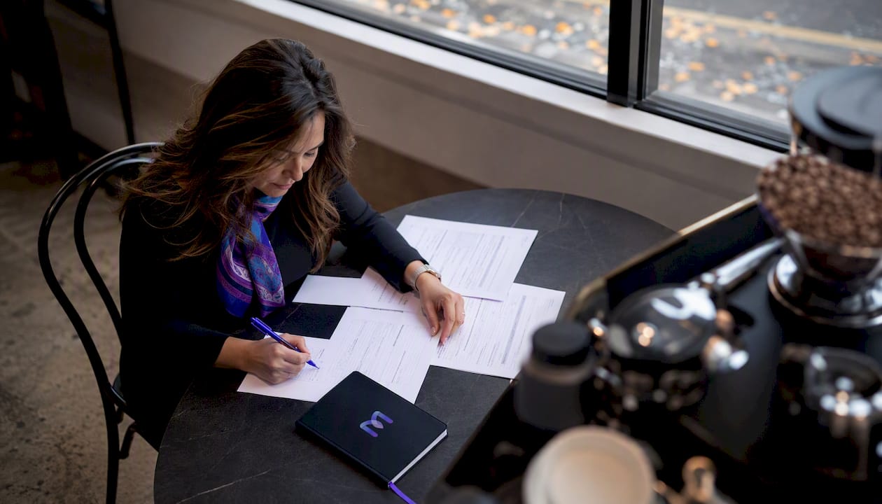 Customer service manager reviewing AI handoff compliance documents
