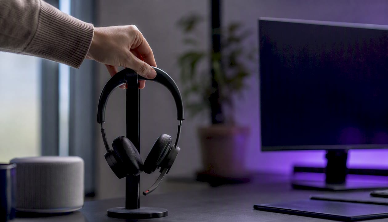 Hand placing headset at AI pilot workspace