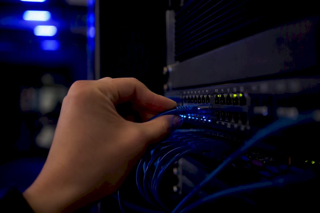 Hand plugging cable into network hub