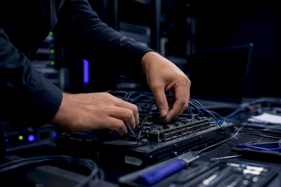 Technician hands adjusting chatbot hardware