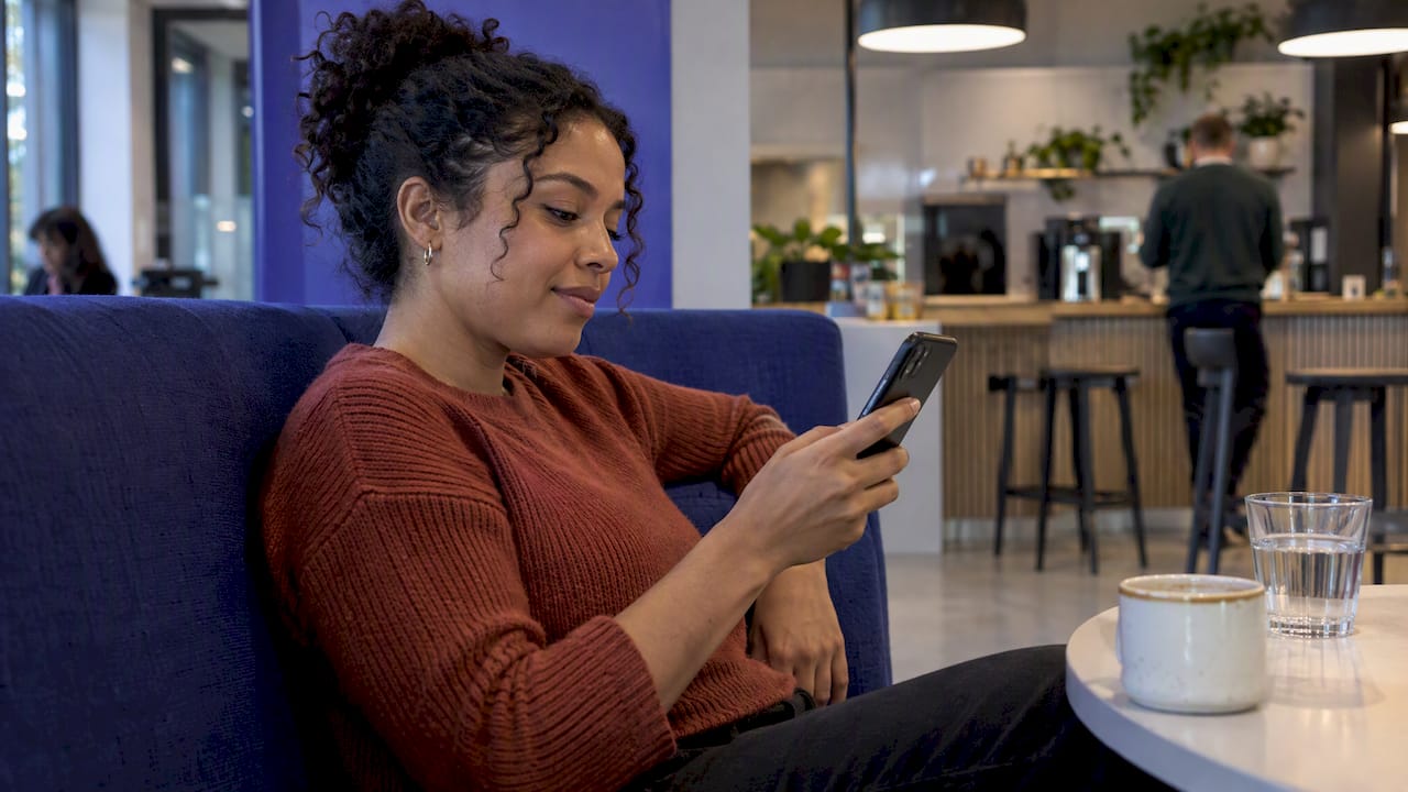 Employee checking an HR chatbot in a lounge